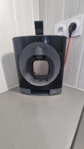 a computer monitor sitting on a counter with a charger at La Mezzanine - 2-4 pers - Centre-Ville in Brassac-les-Mines