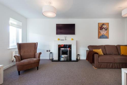 a living room with a couch and a chair at City centre 4 Bed house FREE parking walk to town in Cardiff