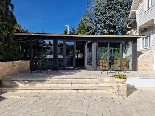a pavilion with chairs and tables in front of a building at Hotel Sunny Hill in Cluj-Napoca