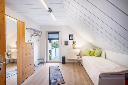 a attic bedroom with a bed and a staircase at Ferienwohnung Familie Süttner in Nagel