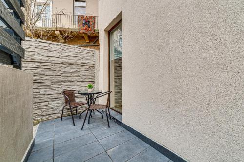 a small patio with a table and two chairs at ARI Central Grand Apartments - Luxurious Stay in Arad