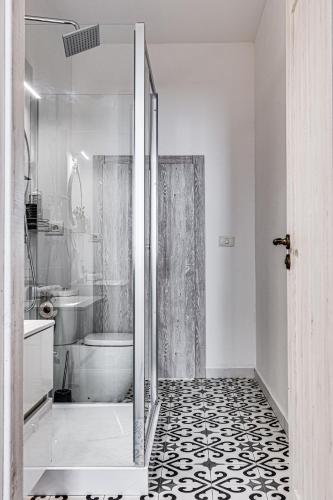 a bathroom with a shower and a toilet at ARI Central Grand Apartments - Luxurious Stay in Arad