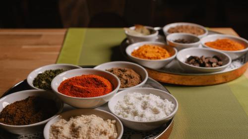 a group of bowls of spices and other ingredients on a table at Hotel Restaurant Taverna in Eching