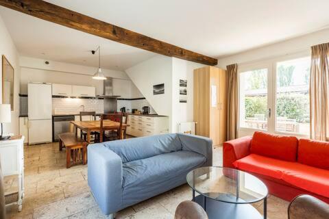 a living room with a blue couch and a table at Ferme de Pontaly in Bailly