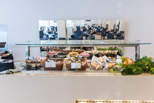 a display case with bread and pastries on display at Seramar Hotel Comodoro Playa in Palmanova