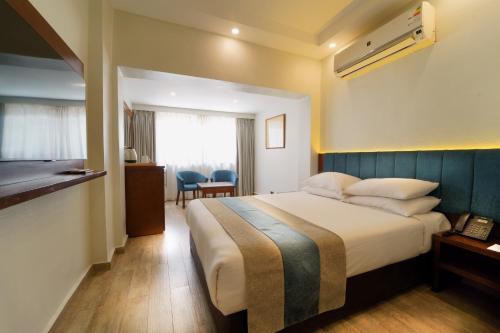 a hotel room with a large bed and a window at Stay Inn Cairo Hotel in Cairo
