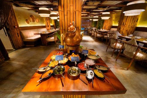 a table with plates of food on it in a restaurant at Stay Inn Cairo Hotel in Cairo