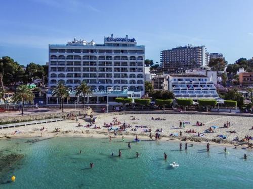 a group of people on a beach in the water at Seramar Hotel Comodoro Playa in Palmanova