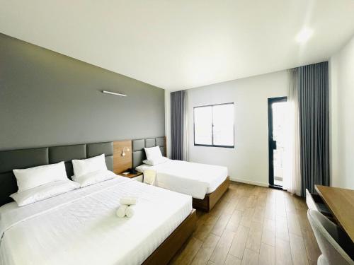 Postel nebo postele na pokoji v ubytování Royal Dragon Boutique Hotel