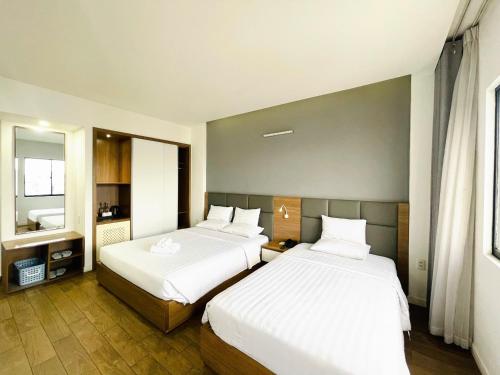 Postel nebo postele na pokoji v ubytování Royal Dragon Boutique Hotel