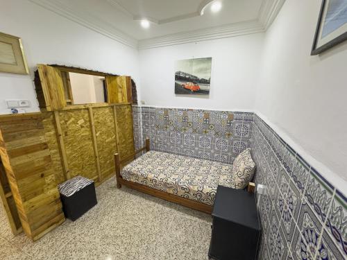 a room with a couch in the corner of a room at Surf & Skate in Taghazout