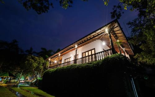 a house lit up at night with lights at Lotus Estate Colombo in Colombo