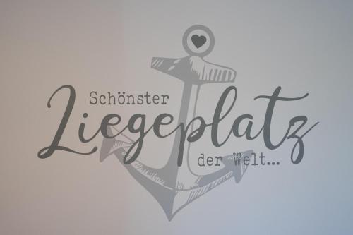 a vector illustration of a seahorse with the text seaman leeperbeit at Fewo Lüttje Parl in Hooksiel