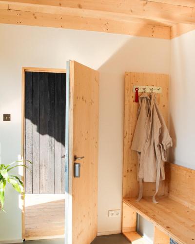 a room with a wooden door and a closet at Veritas Beyond Glamping in Hošťka
