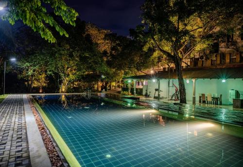 a swimming pool in a park at night at Lotus Estate Colombo in Colombo