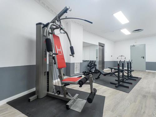 a gym with several tread machines in a room at VTZ Hotel El Príncipe in Zaragoza