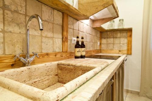a kitchen with two bottles of wine on a counter at Isola Sarda Appart NICE in Murta Maria