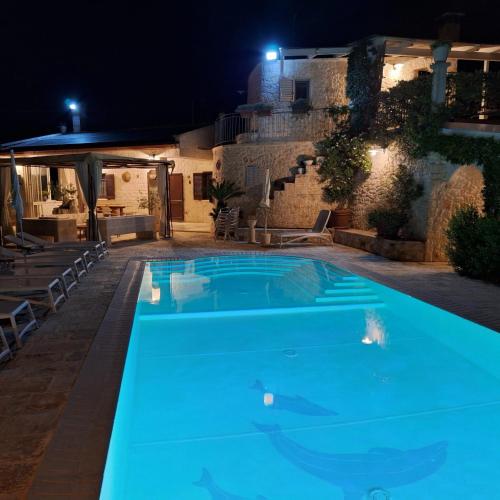 a swimming pool in the middle of a house at night at Villa Belvedere in Ostuni