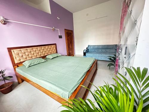 a bedroom with a bed in a room with plants at Kuhipaat Homestay in Guwahati