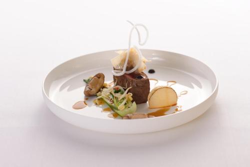 a plate of food on a white plate at Hotel Adler Asperg in Asperg