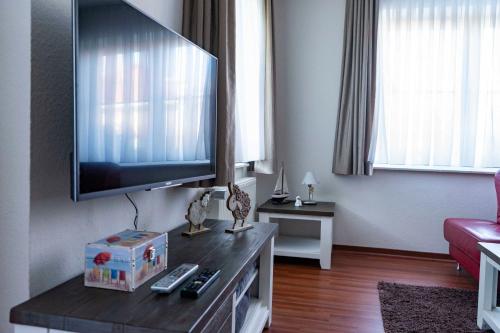 a living room with a large flat screen tv at Ferienwohnung Krabbe in Hooksiel