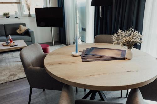 a wooden table in a living room with a dining room table at Fewo Alk Obergeschoss in Hooksiel