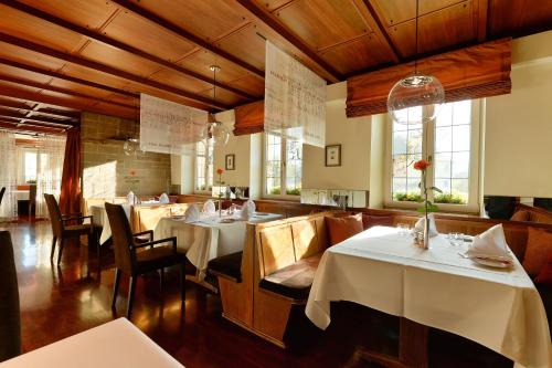 a dining room with white tables and chairs at Hotel Adler Asperg in Asperg