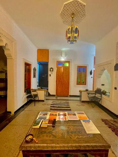 a living room with a table with books on it at Blue Star Hostel in Fès