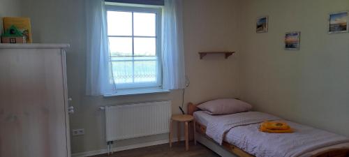 Postel nebo postele na pokoji v ubytování Ferienhaus und Fewo Anna Nommsen