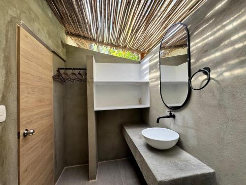 a bathroom with a sink and a mirror at Rosario EcoHotel in Isla Grande