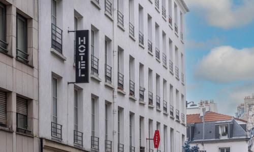 a white building with a sign on the side of it at Hotel Daval in Paris