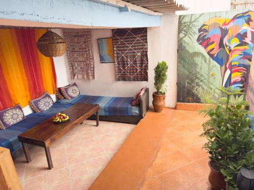 a living room with a couch and a table at Surf & Skate in Taghazout
