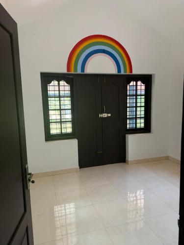 a room with a rainbow on the wall at Dream House Near IIM Kozhikode & NIT Calicut in Kozhikode