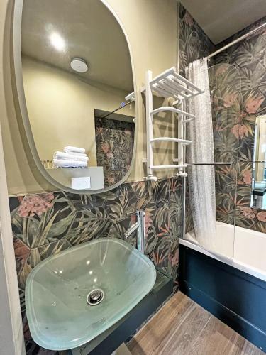 a bathroom with a sink and a mirror at Shillingford Bridge Hotel in Wallingford