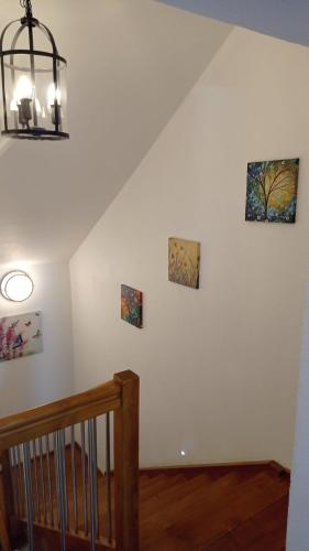 a staircase with three pictures on the wall at Ferienhaus am Bach in Achslach