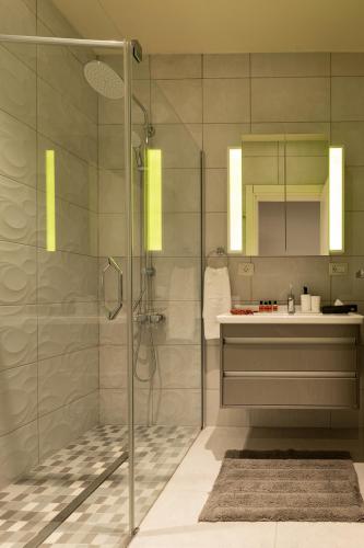 a bathroom with a shower and a sink at Dreamland Golf Hotel Baku in Baku