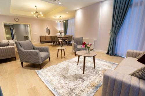 a living room with couches and chairs and a table at Dreamland Golf Hotel Baku in Baku