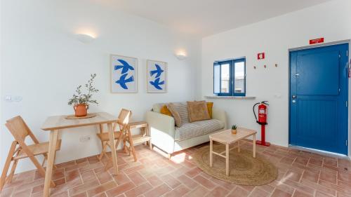 a living room with a couch and a table at Stylish Slow Living 1 BDR House by LovelyStay in Vila do Bispo