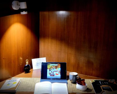 a laptop computer sitting on top of a table at Victorian Elegance Luxury Stays in Amritsar