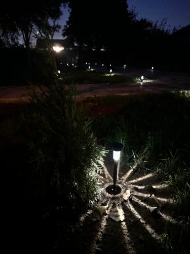 a light in the middle of a sidewalk at night at Hovakimyans Hotel And Pool Airport in Armavir