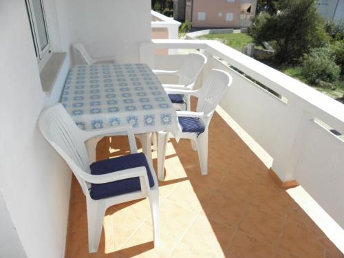 a table and chairs sitting on a balcony at Apartments Vink in Vir