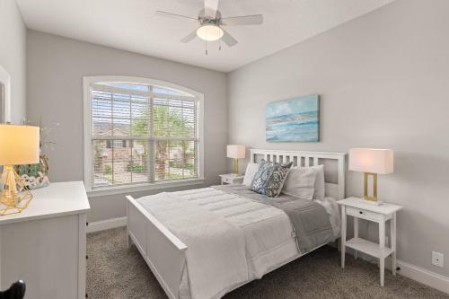 a bedroom with a bed and two lamps and a window at Mariners Getaway in Saint Simon Mills