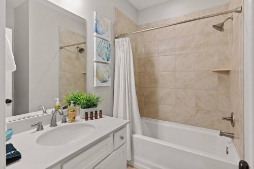 a bathroom with a white sink and a shower at Mariners Getaway in Saint Simon Mills