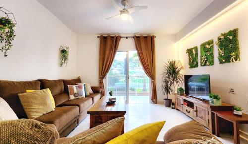 a living room with a couch and a tv at CSS Comfy Smart Superior By King's Palace in Paphos City
