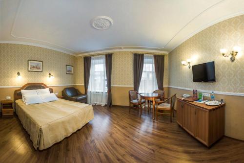 a hotel room with a bed and a table at Hotel Gogol House in Saint Petersburg