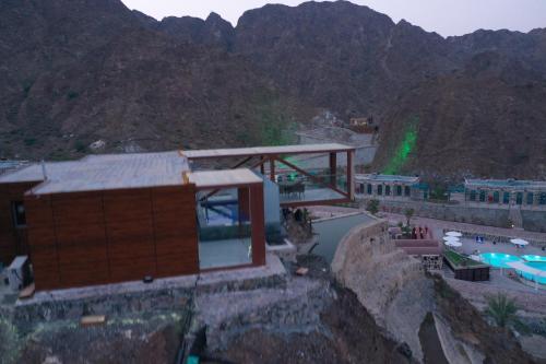 a building on top of a mountain with a pool at Dibba Mountain Park Resort in Fujairah