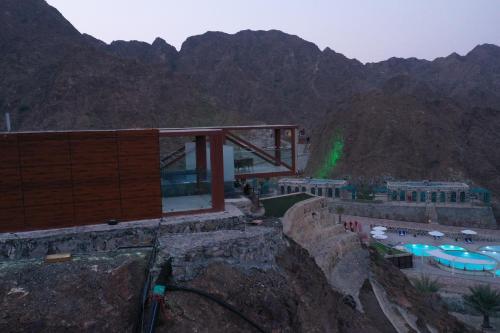 a building on the side of a mountain at Dibba Mountain Park Resort in Fujairah