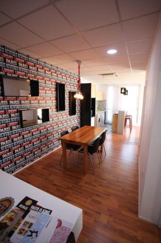 a room with a wooden table and a brick wall at G.R City Heart in Nicosia