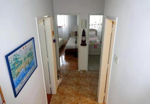 a hallway with a room with a bed and a room with at Apartment Ljubav in Makarska