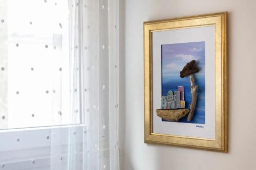 a framed picture of a city on a wall at Apartment Ljubav in Makarska
